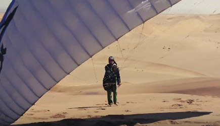 Paragliding Over A Sea Of Sand Dunes In Namibia